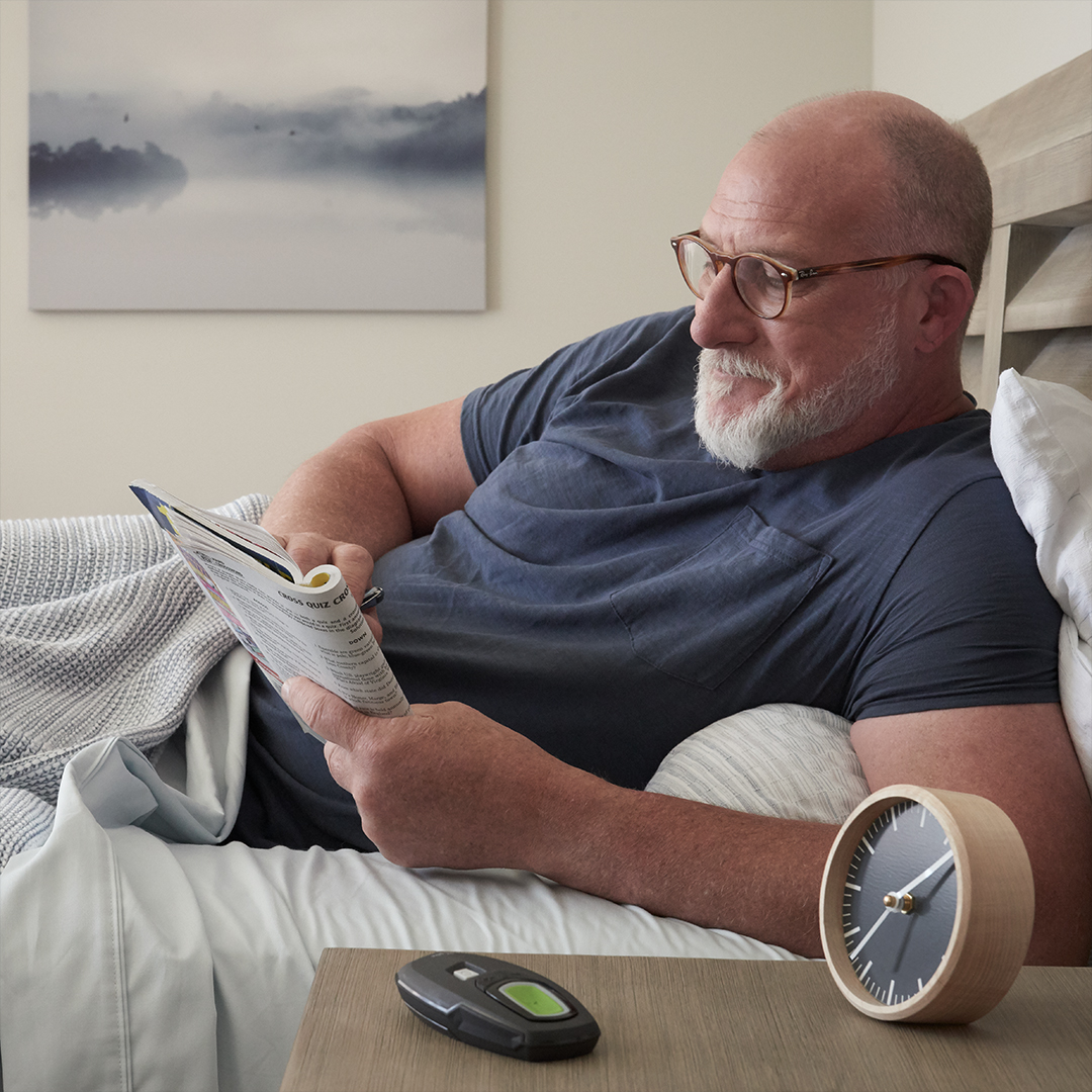 Man reading magazine in bed Man reading magazine in bed